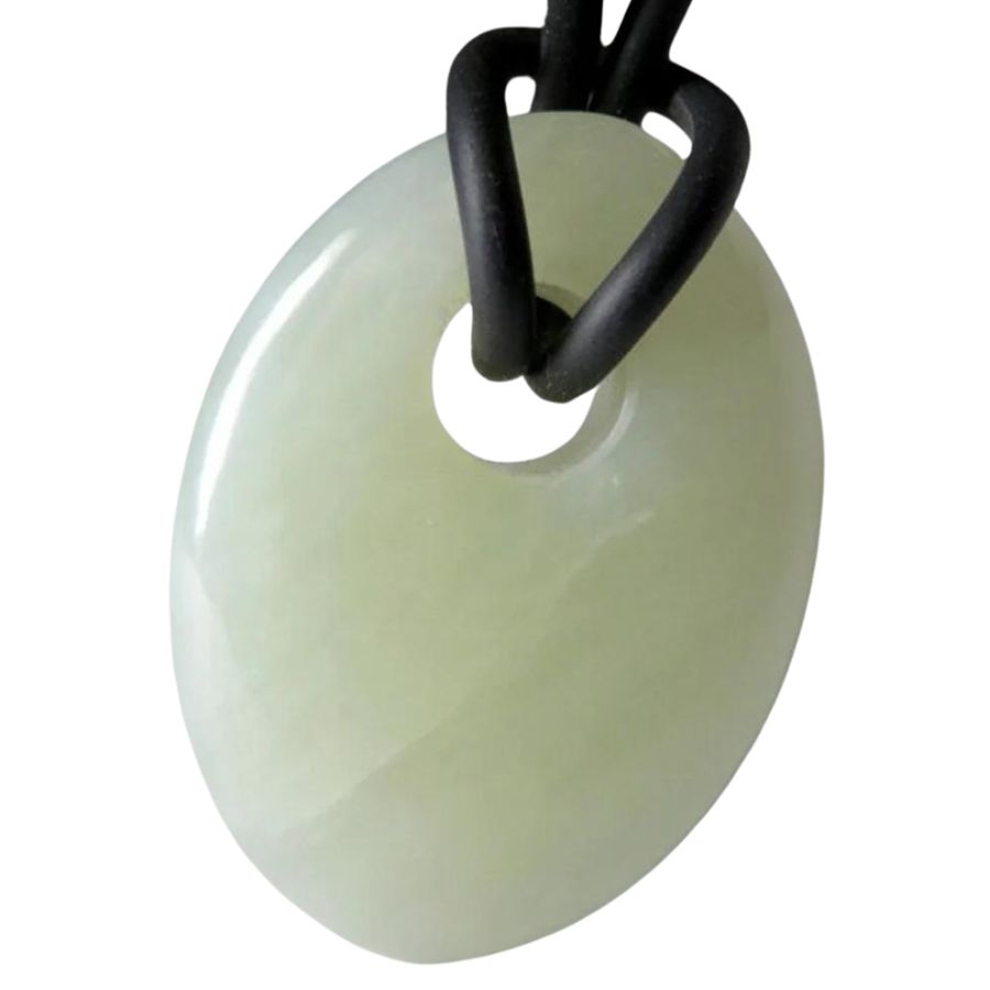 oval white jade pendant with a hole
