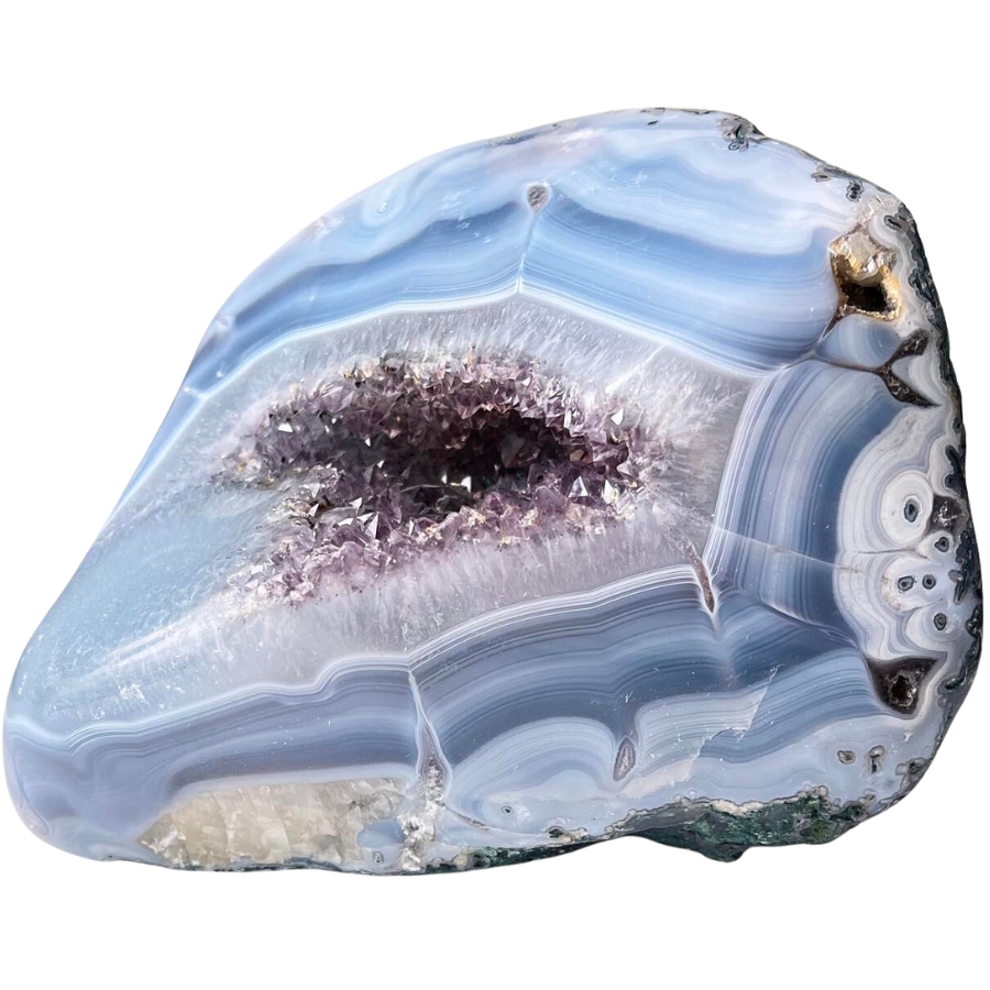 A beautiful agate geode showing light to dark blue bands with amethyst crystals in the middle