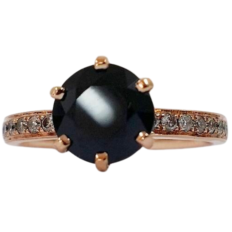 A round black sapphire installed as center stone in a diamond-studded ring