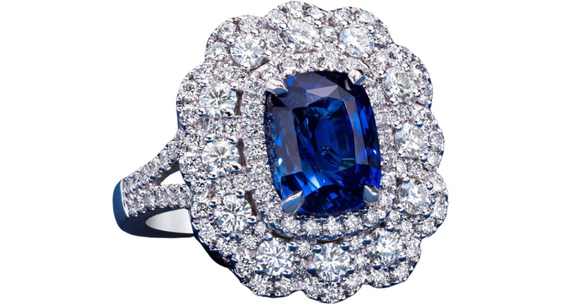 A floral halo of white diamonds surrounding a big, lustrous blue sapphire
