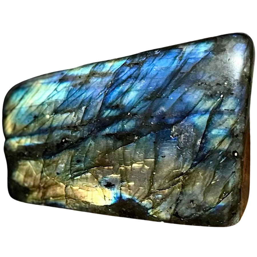 A polished piece of rectangular labradorite displaying different colors of labradorescence