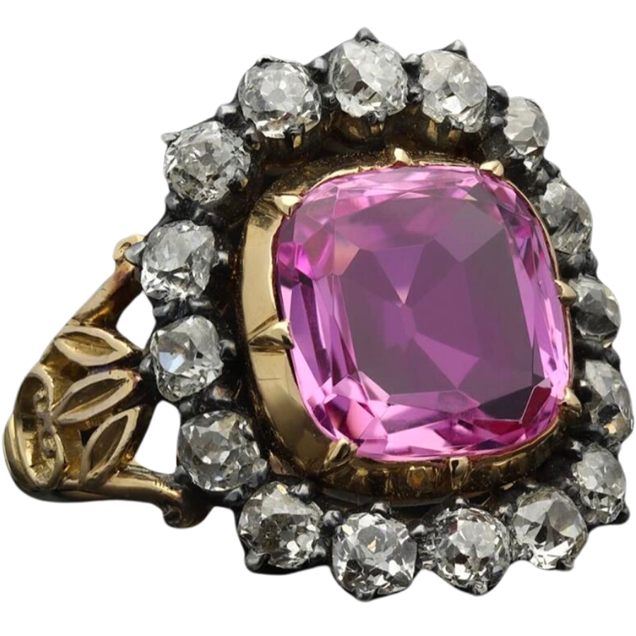 A ring with a cluster of small diamonds and a big Victorian pink topaz as center stone