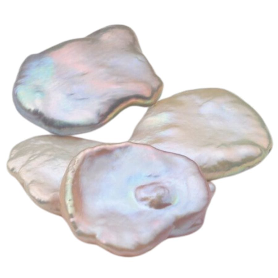 four irregularly shaped flat Keshi pearls