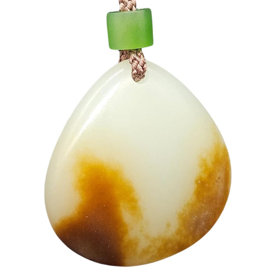 white and brown teardrop shaped Siberian jade pendant