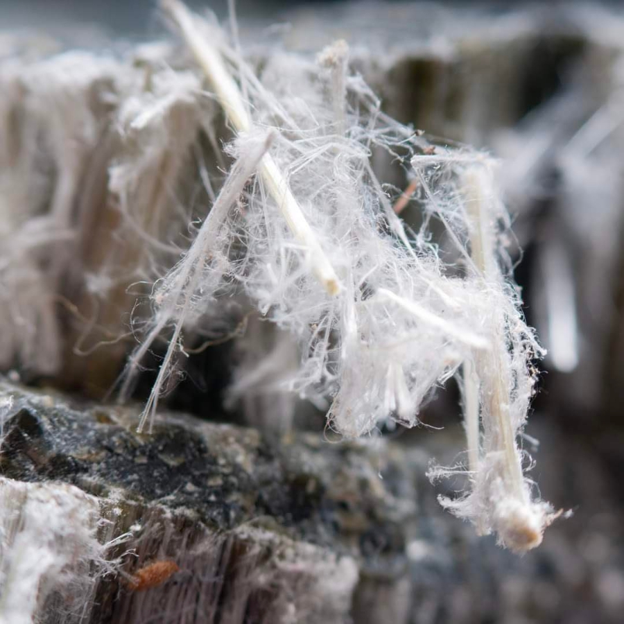 White, thin fibers of asbestos focused against the background of the crystal
