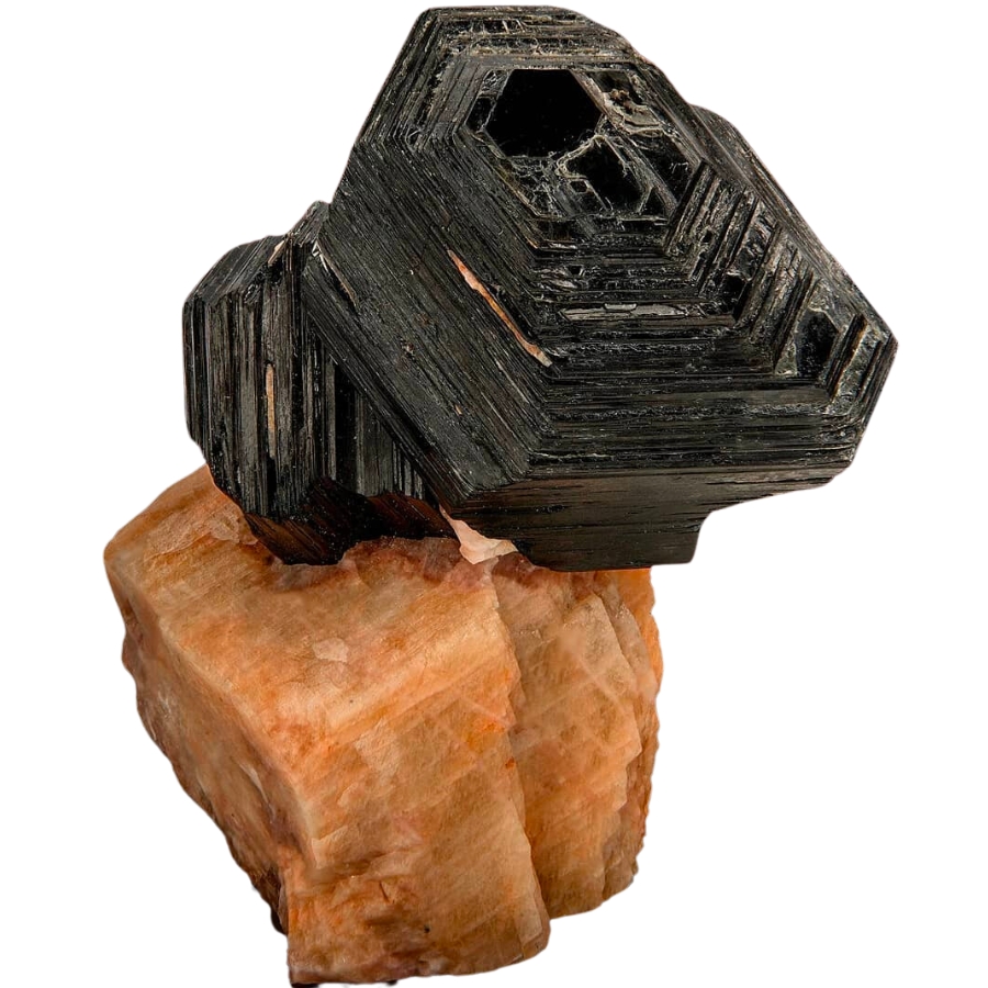 Hexagonal black biotite crystals on a flesh-colored calcite matrix