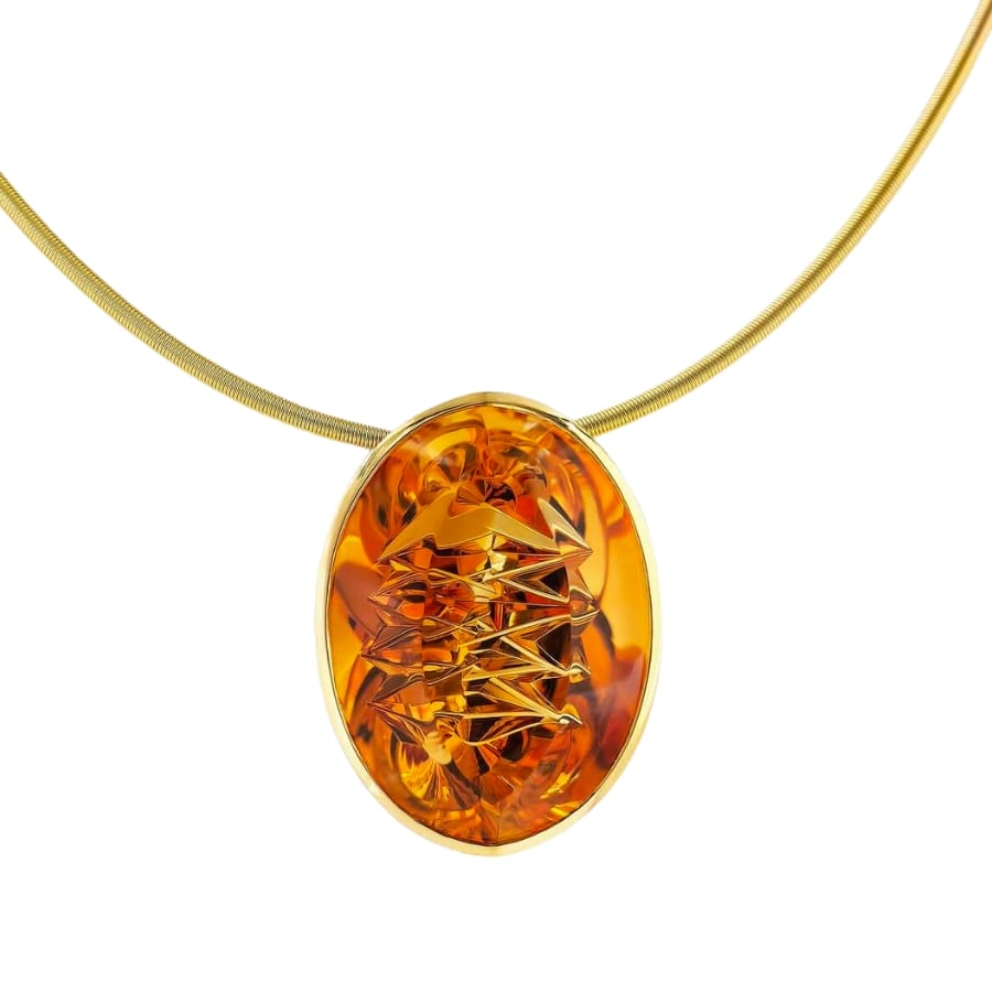 A sparkling rich orange citrine pendant on a gold necklace