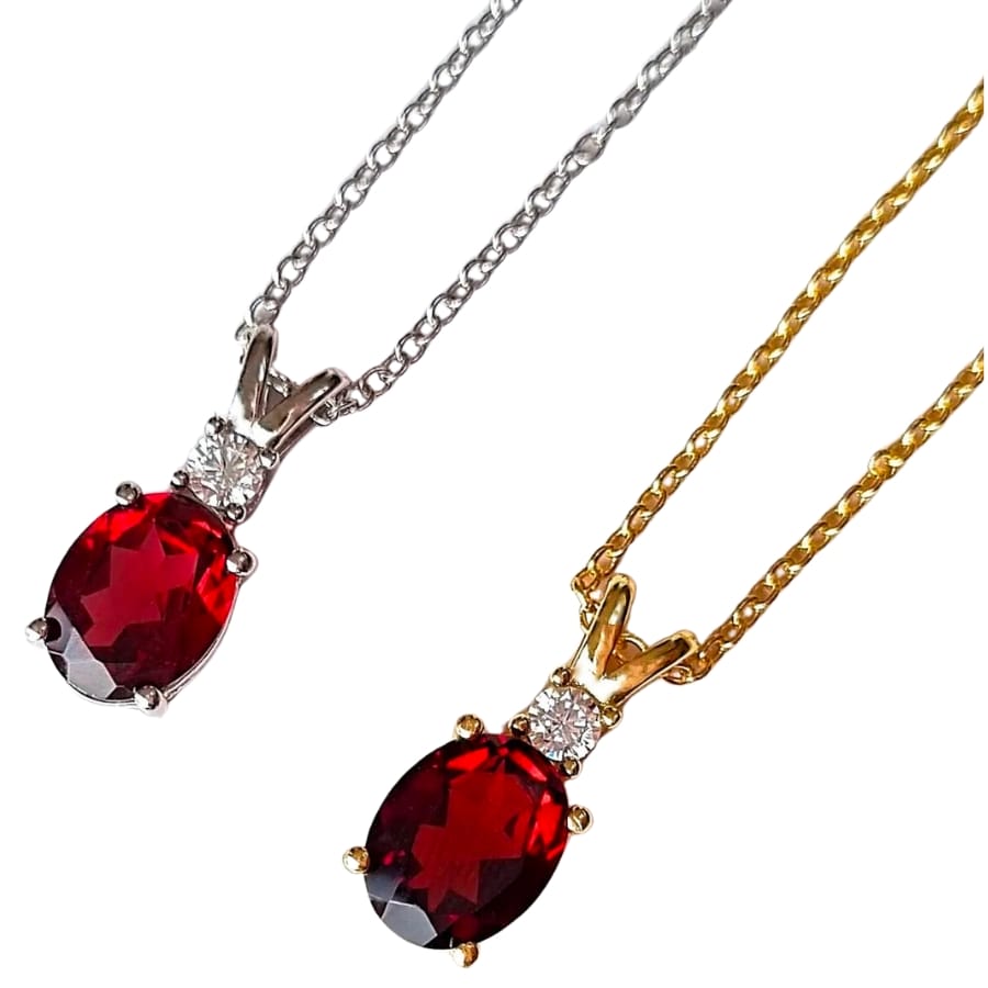 Silver and gold necklaces both with deep red garnet pendants