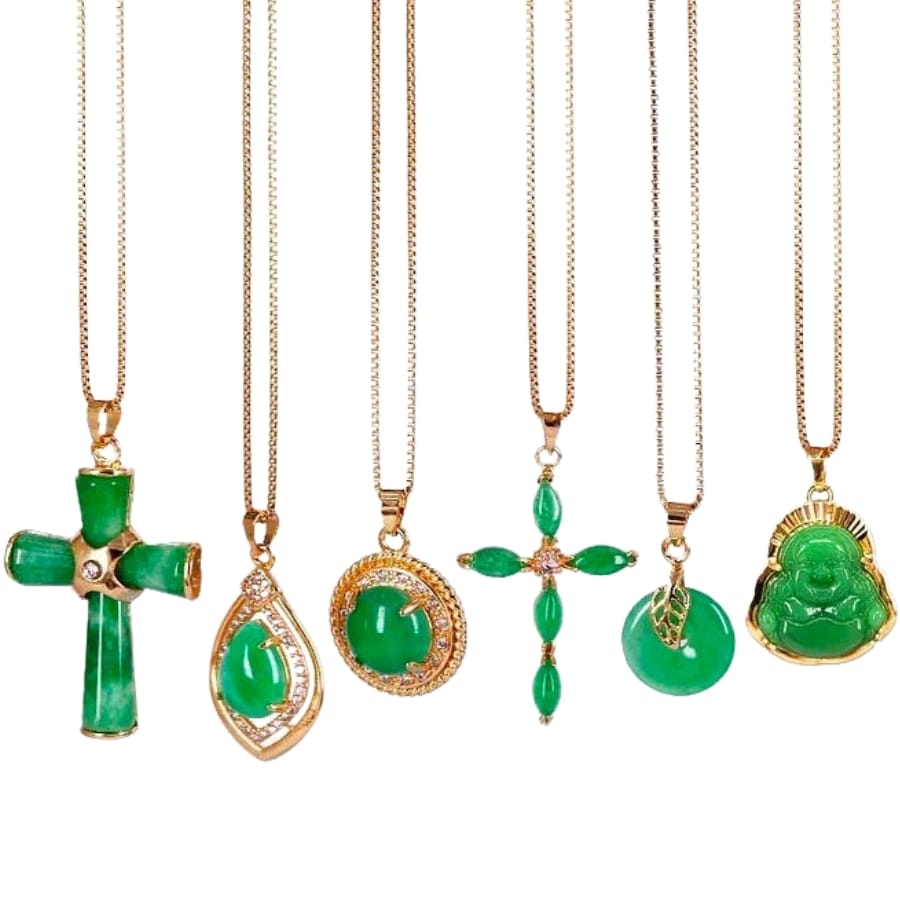 A collection of jade-adorned pendants on gold necklaces