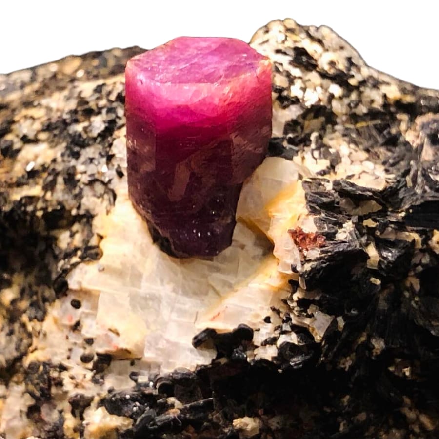 A pinkish Madagascar ruby perched on a biotite matrix