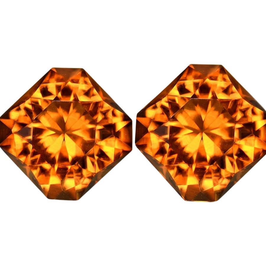 A pair of faceted madeira citrine showing deep, rich orange hues