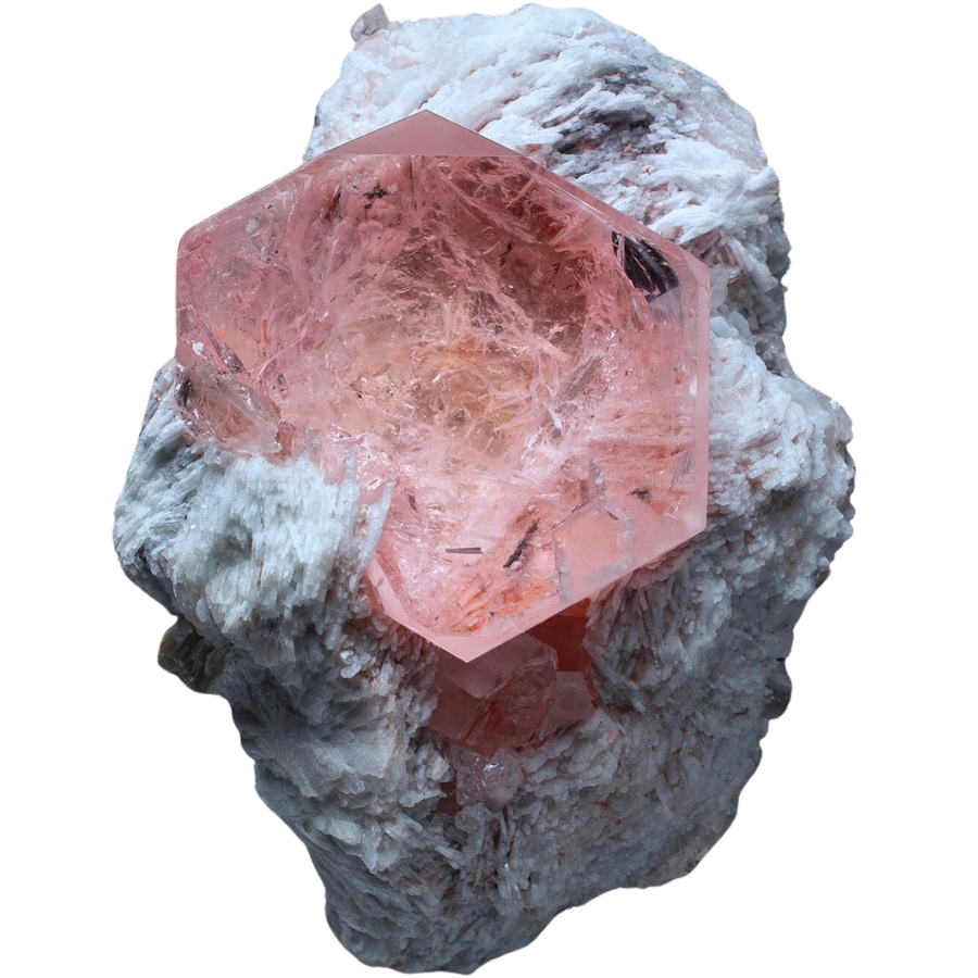 A soft pink morganite crystal perched on a white matrix