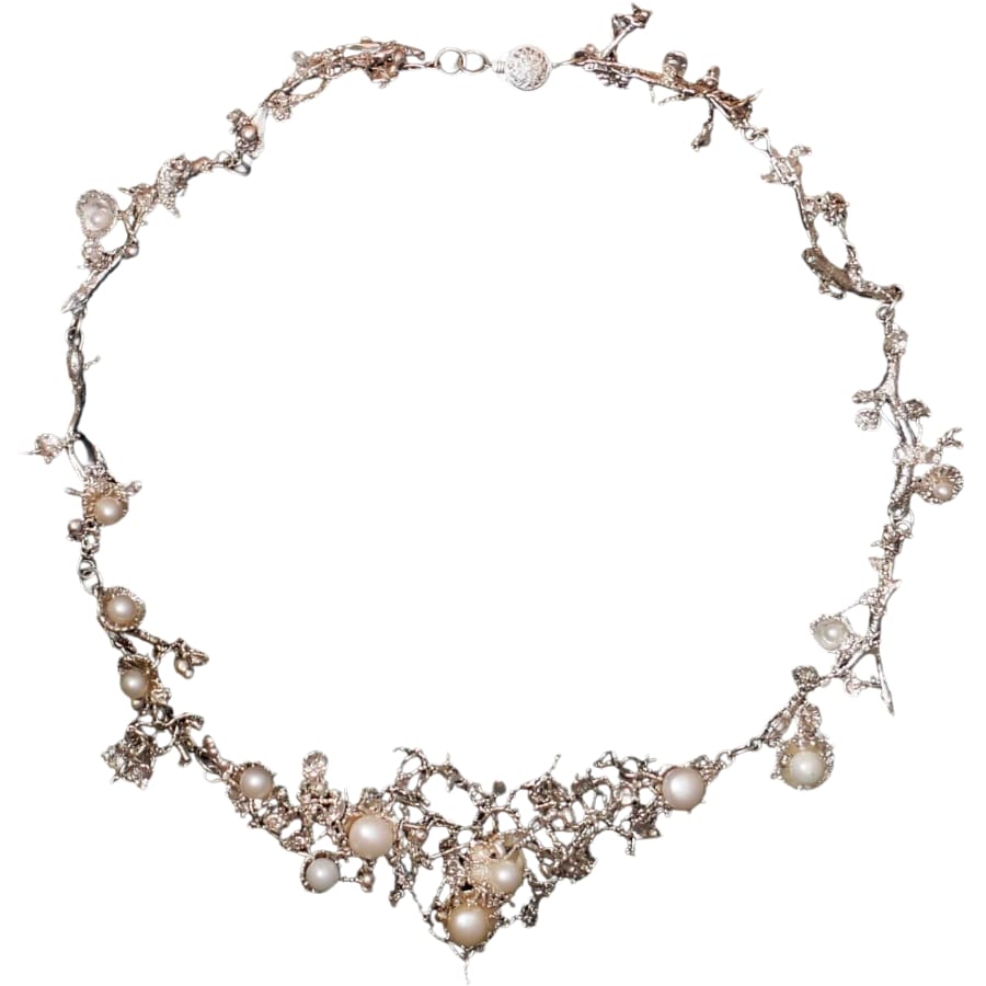 A sterling silver necklace adorned with white pearls