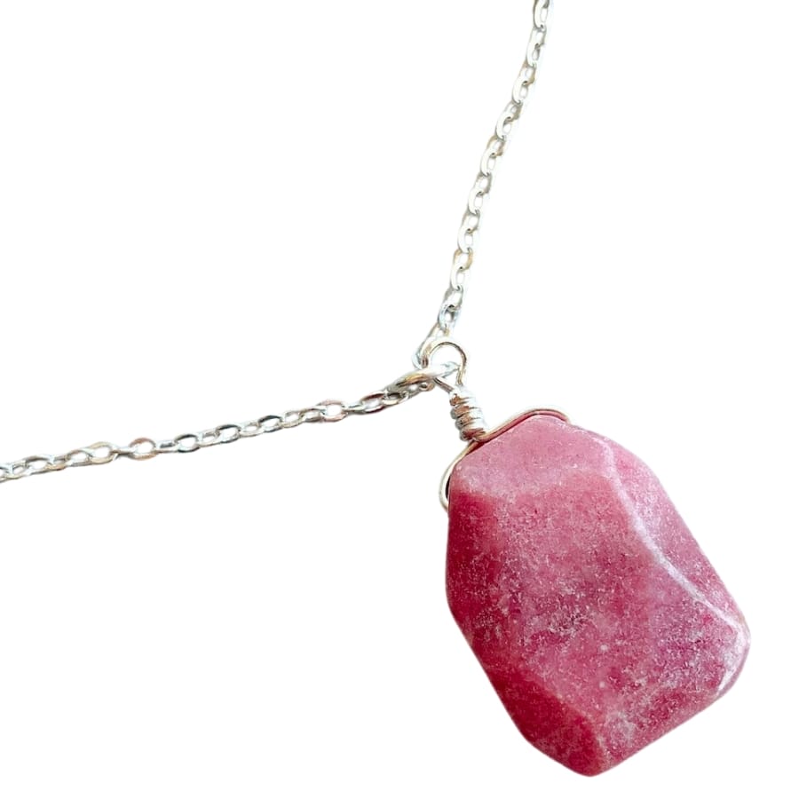 A light red pendant on a necklace