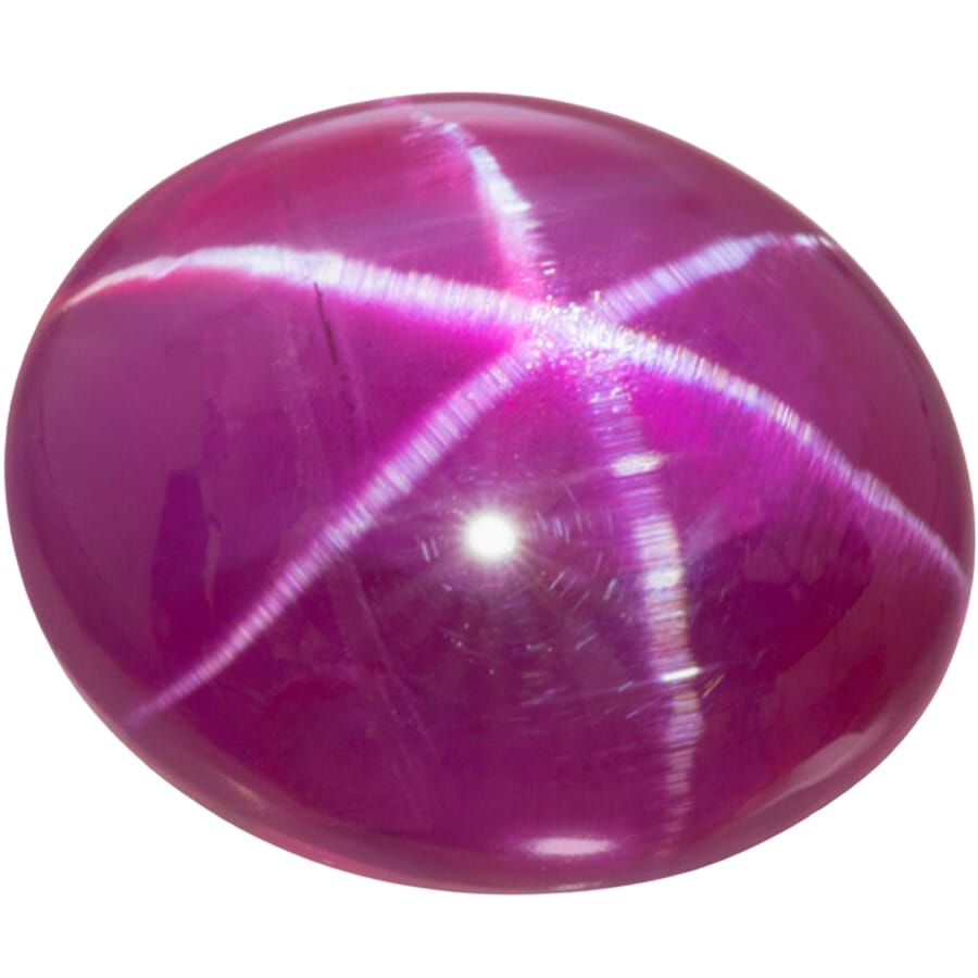 A round, polished piece of star ruby showing clear asterism or star pattern