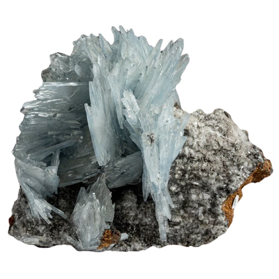 pale blue needle-like barite crystals on a rock