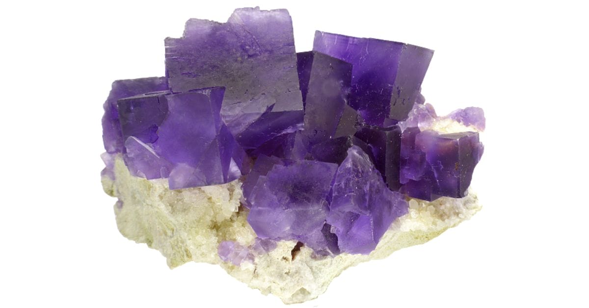 cubic purple fluorite crystals on a rock