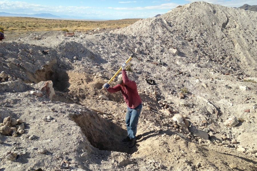 A man about to strike at the collecting site of the Dugway Geode Beds