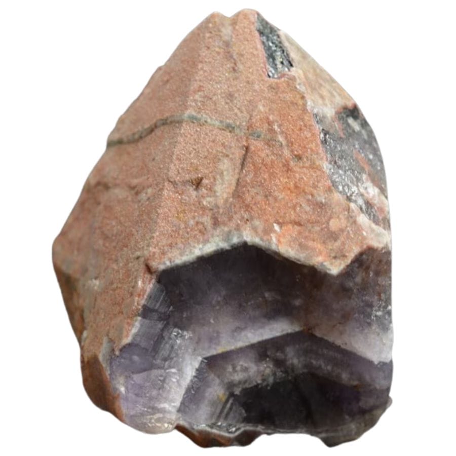 rough auralite with an orange crust covering a purple crystal