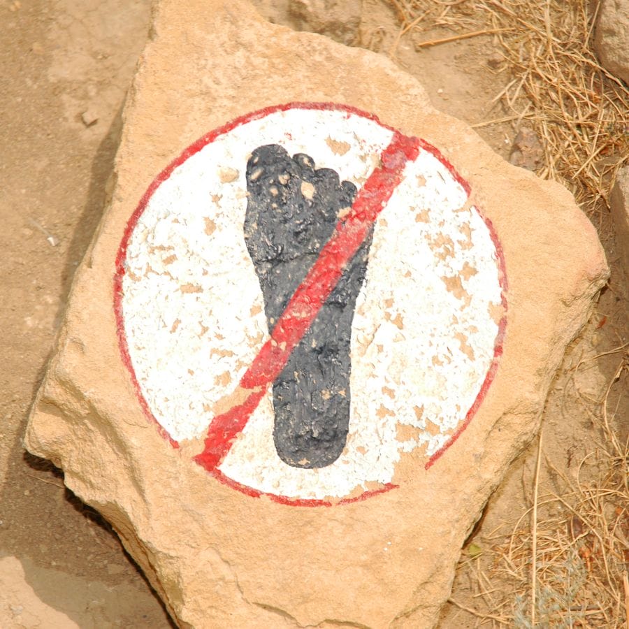 black footprint painted on a rock