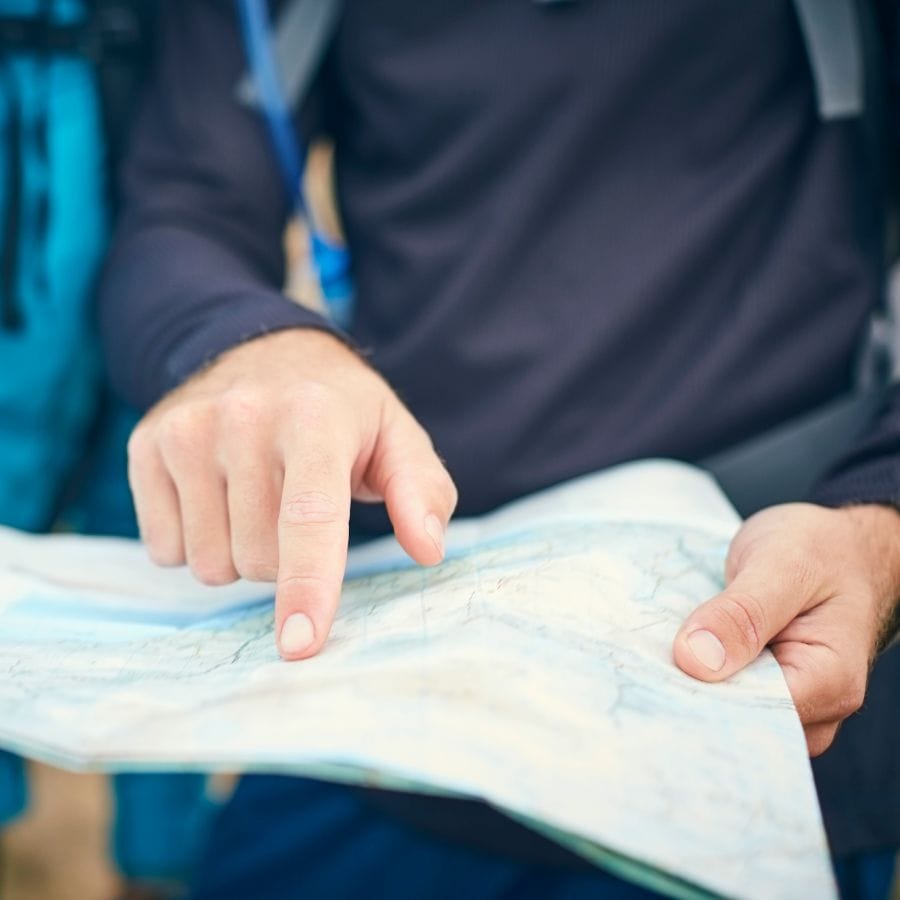 person pointing at a map