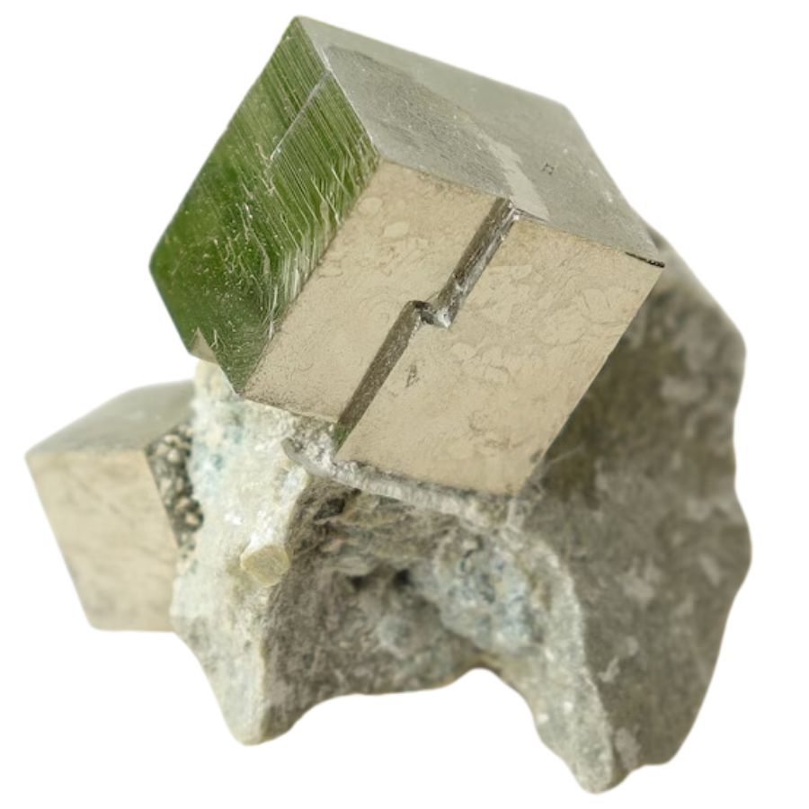 golden cubic pyrite crystal on a rock