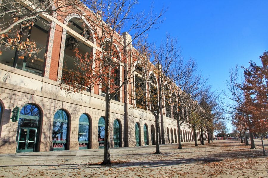 large brick building lined by trees