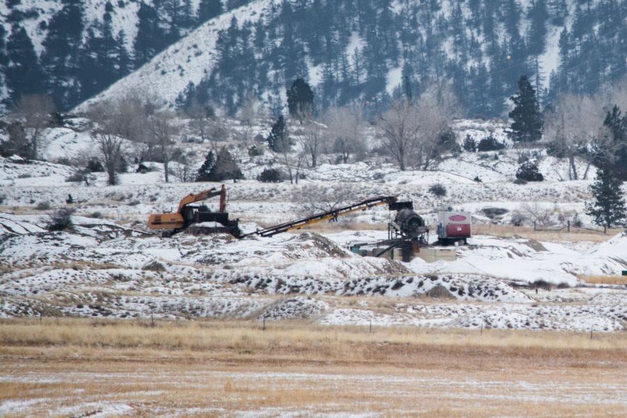 excavators on the snowy banks of the Missouri River