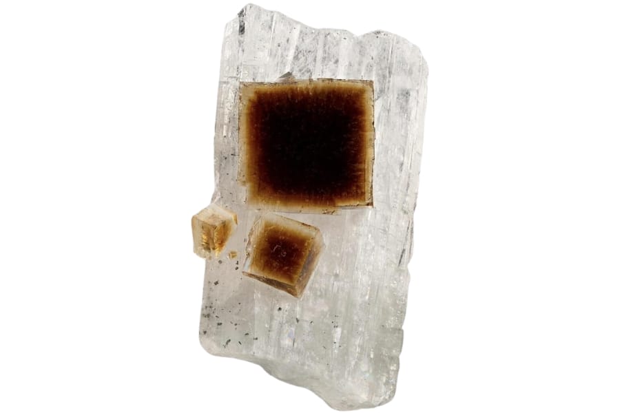 Deep to light brown cubes of fluorite on a white crystal of celestine from Clay Center