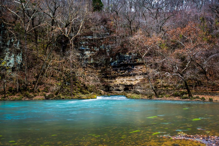 blue waters with rocks and trees