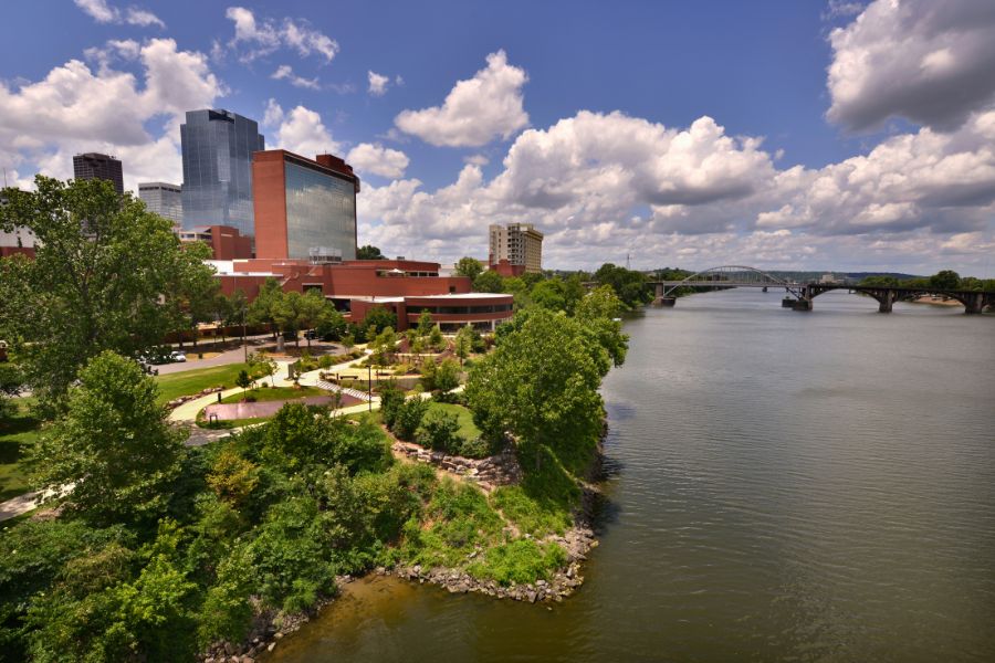 aerial view of a park, river, and bridge