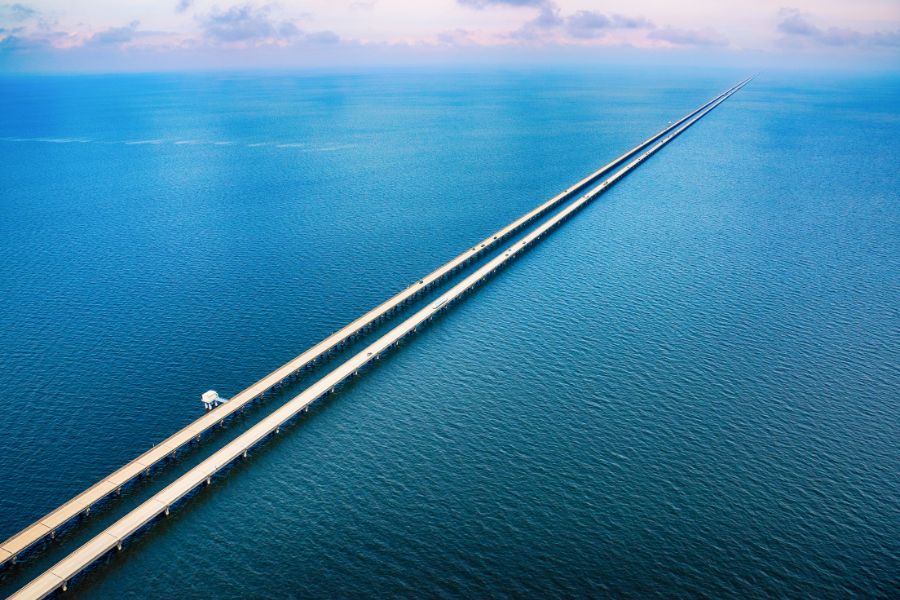 aerial view of a long bridge across a large lake