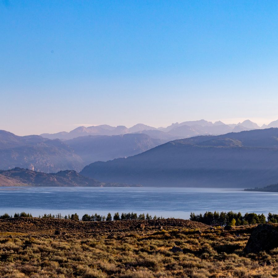 lake shore with mountains on the horizon