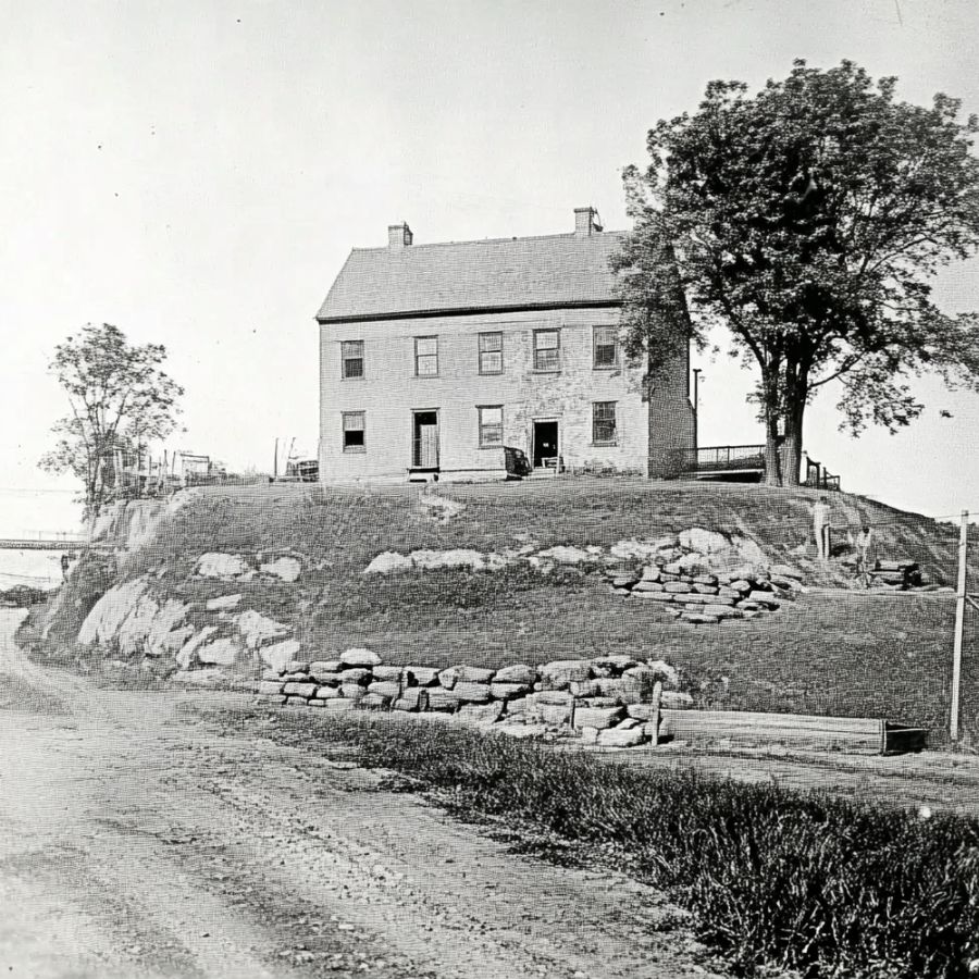 two-story house next to a large tree