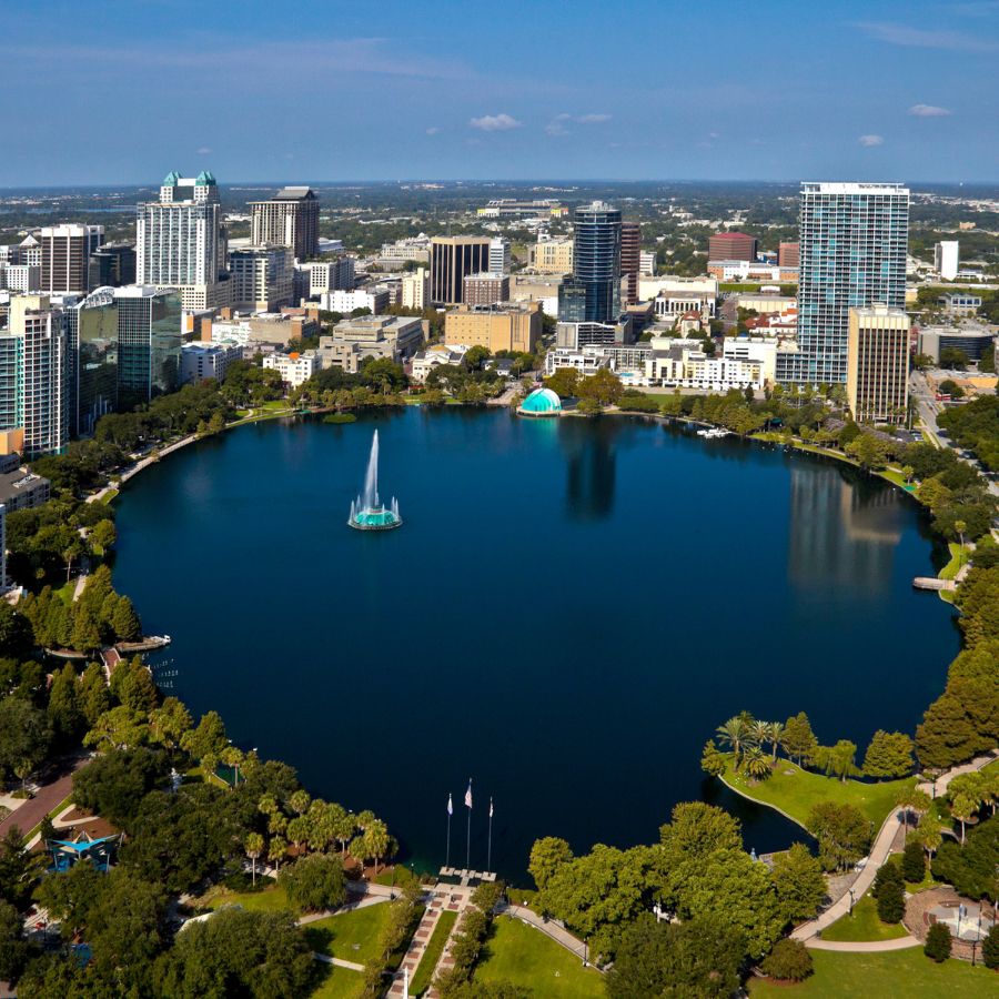 aerial view of a lake surrounded by buildings and trees