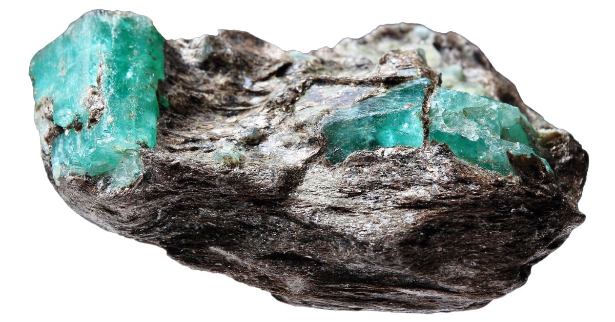 bright green raw emerald crystals on a rock