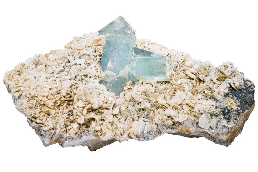 pale blue aquamarine crystals on a rock matrix
