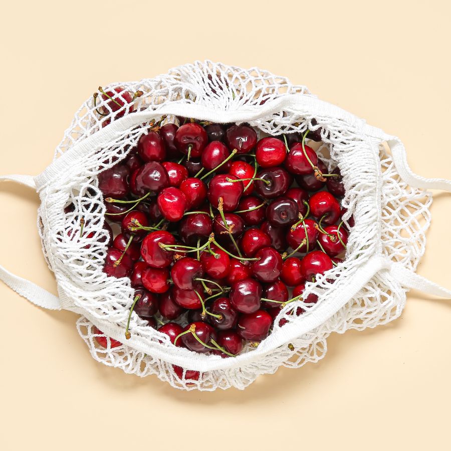 cherries in a white mesh bag