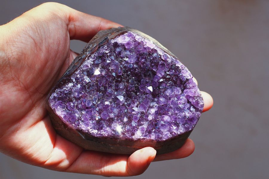 Hand holding a piece of amethyst from North Carolina