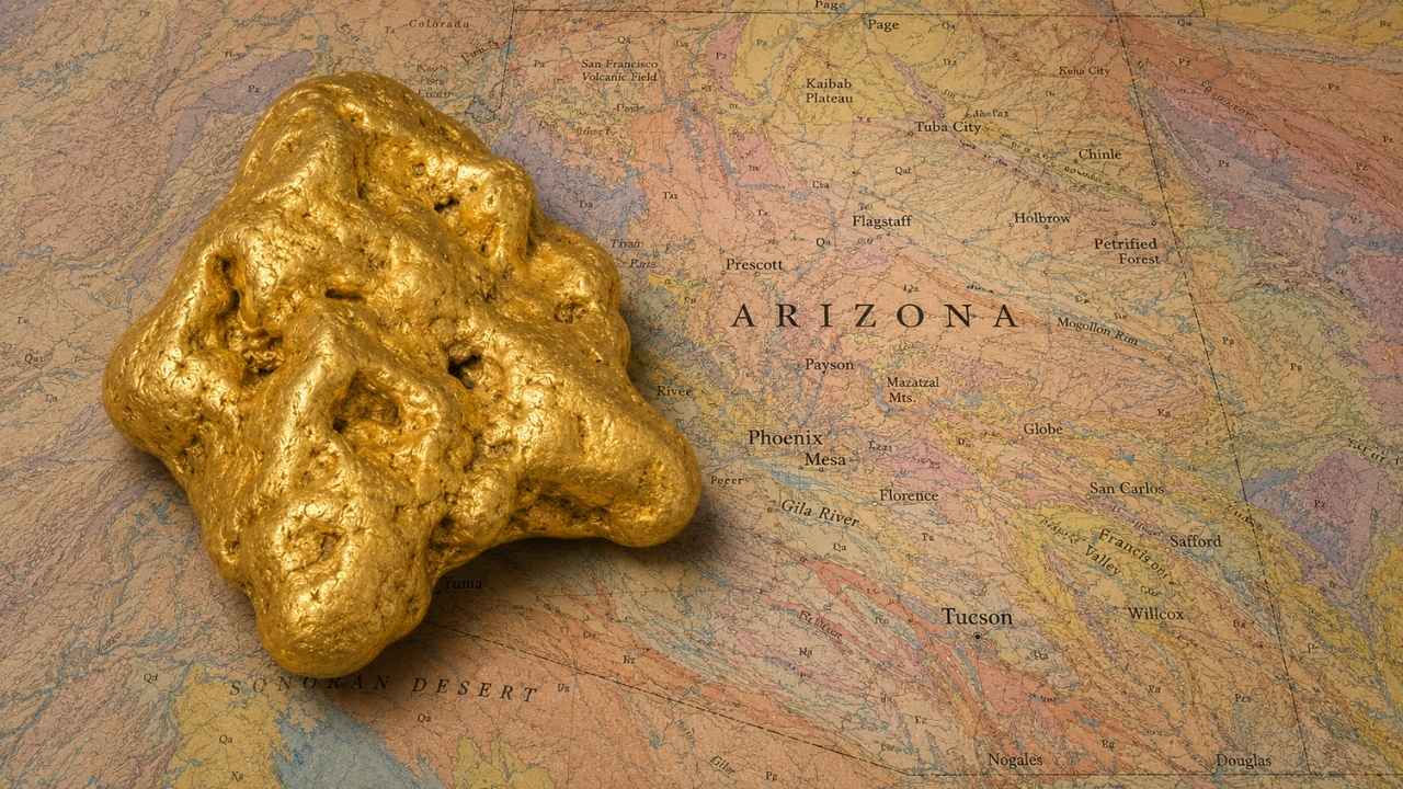 Gold nugget resting on a geological map of Arizona