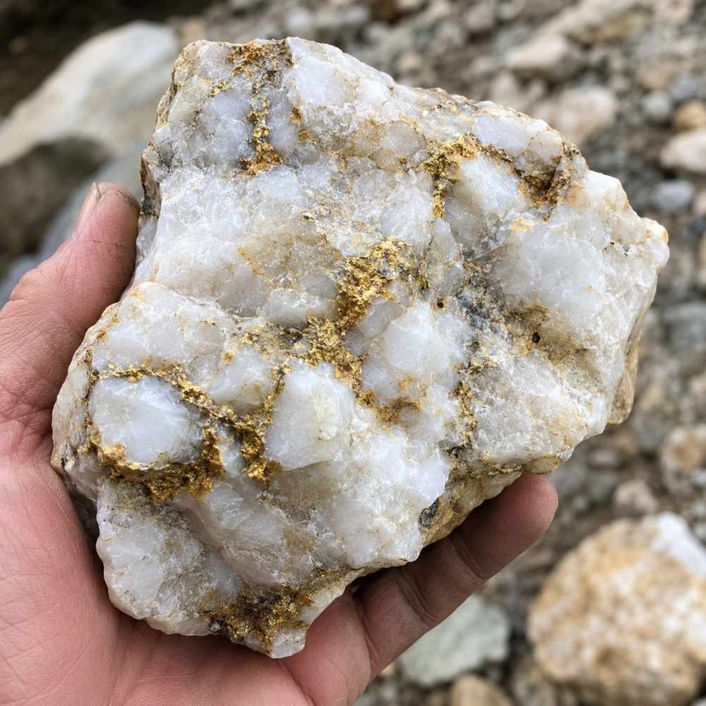 Gold veins running through white quartz like the vein gold found in Maine